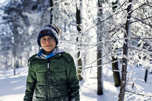 Portrait of a teenage boy enjoying beautiful winter day stock photo
