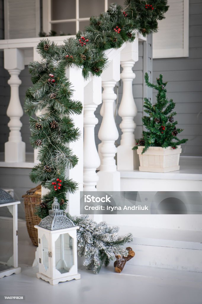 Christmas morning. porch a small house with a decorated door with a Christmas wreath. Winter fairy tale. Christmas morning. porch a small house with a decorated door with a Christmas wreath. Winter fairy tale Christmas Stock Photo