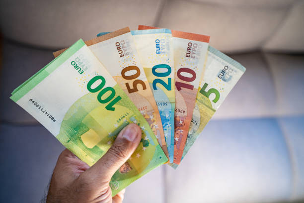 istock Man holding euro banknotes 1440192898