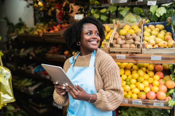 Portrait of a young African American woman running business at her small grocery store stock photo
