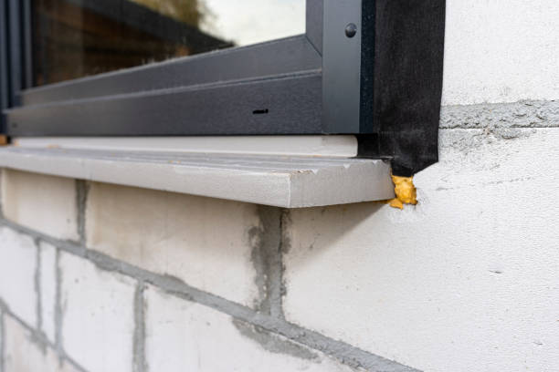 istock Warm installation of a three-layer window with a polystyrene window sill, view from the outside. 1440202110