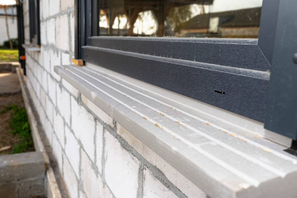 istock Warm installation of a three-layer window with a polystyrene window sill, view from the outside. 1440202137