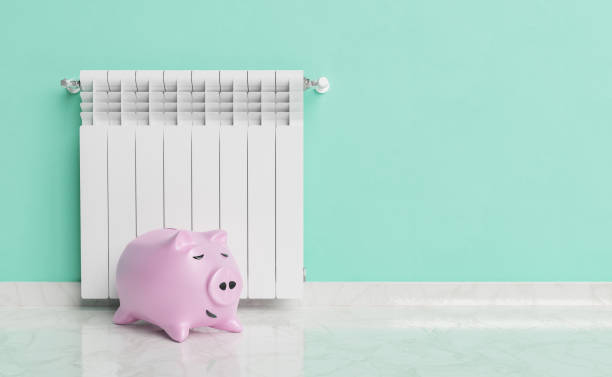 istock Piggy bank placed near radiator 1440202233