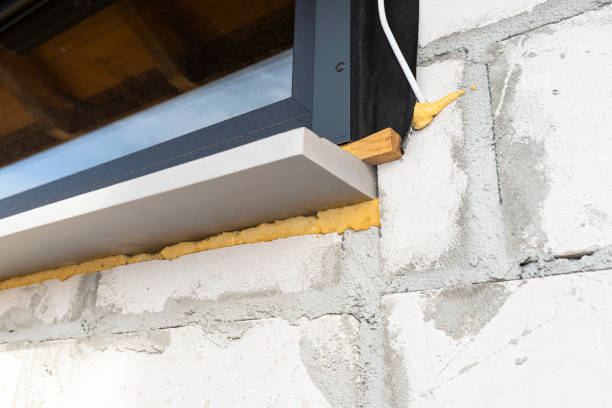 istock Warm installation of a three-layer window with a polystyrene window sill, view from the outside. 1440202407