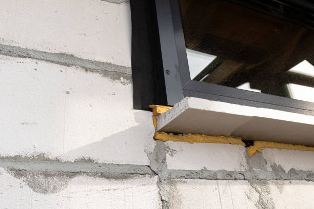 istock Warm installation of a three-layer window with a polystyrene window sill, view from the outside. 1440202525