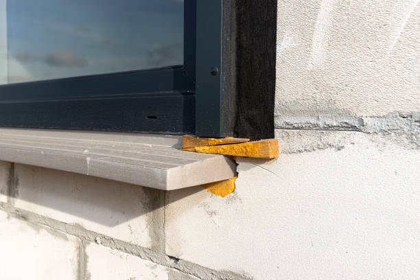 istock Warm installation of a three-layer window with a polystyrene window sill, view from the outside. 1440203108