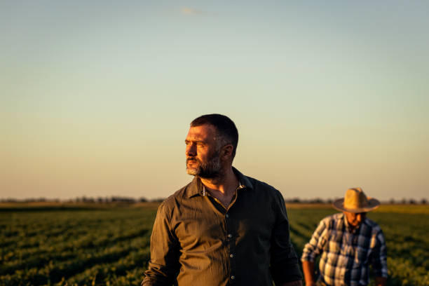 istock Two farmers in a field examining soy crop. 1440203118