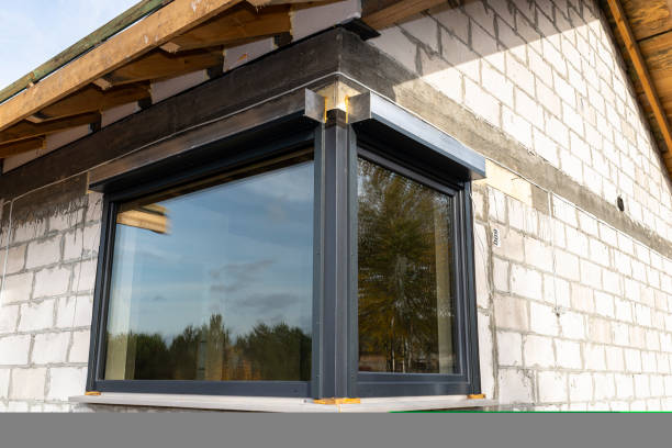 istock Warm installation of a three-layer window with a polystyrene window sill, view from the outside. 1440203137