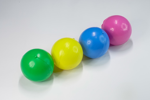 Magelang, Central Java, Indonesia, various color of plastic ball on white background.