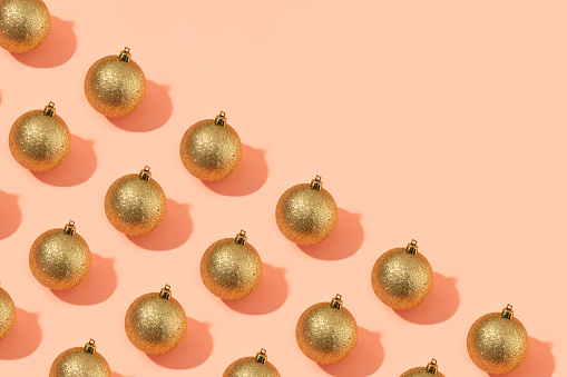 Christmas bauble ornaments in a row on pink background