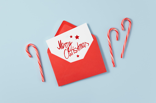 Red envelope with Christmas greeting message with candy canes