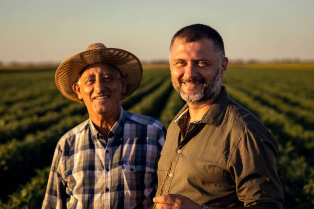 istock Two farmers in a field examining soy crop. 1440206110