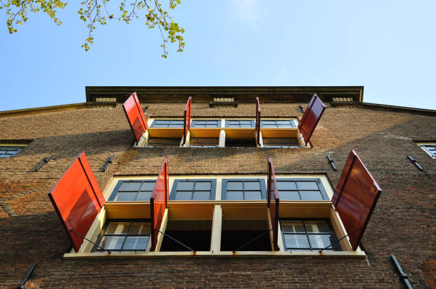 Beautiful building with open sun blinds and windows in Amsterdam, Holland Netherlands