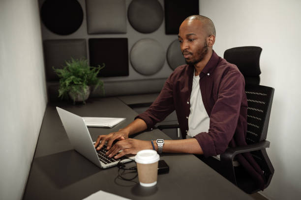 istock African businessman working alone in an office cubicle 1440208590