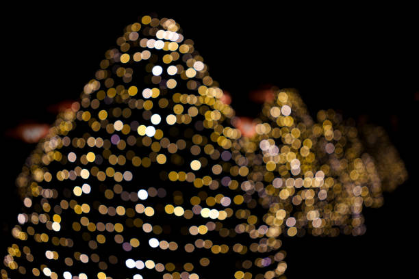 istock Golden blurred lights on Christmas trees 1440209945