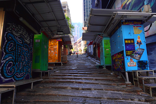 Hong Kong - November 24 2019: Pottinger Street or Stone Slab Street in Central. The street is paved unevenly by granite stone steps. It was named in 1858 after Henry Pottinger