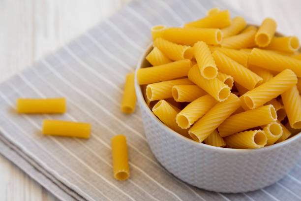 istock Dry Rigatoni Pasta in a gray Bowl, side view. Copy space. 1440213884