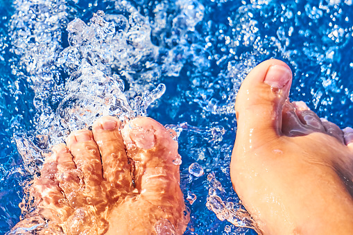 feet of a girl in the pouring water