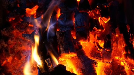 Hot coals of a fire in the oven. Combustion temperature. Burning coals inside the fireplace.