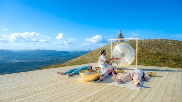istock People group at sound therapy session, man playing bronze gong 1440215570