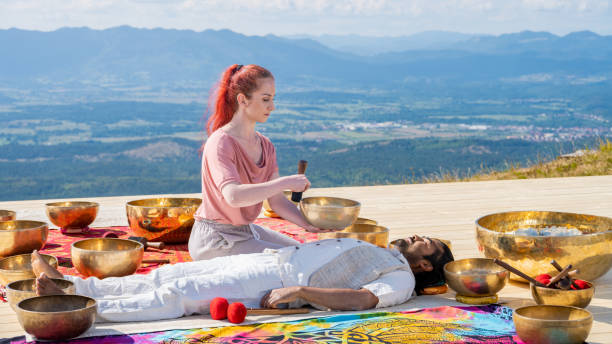 istock Singing bowls meditation, music therapy session, side view 1440215589