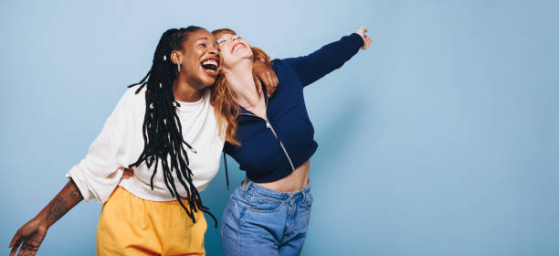 istock Two happy best friends laughing and having a good time while embracing each other 1440216861