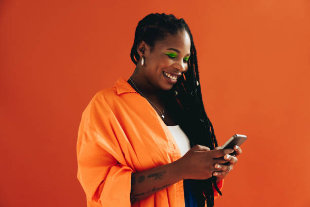 istock Young woman texting on her smartphone in a studio 1440217389