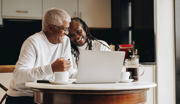 istock Senior couple using a laptop together at home 1440217557