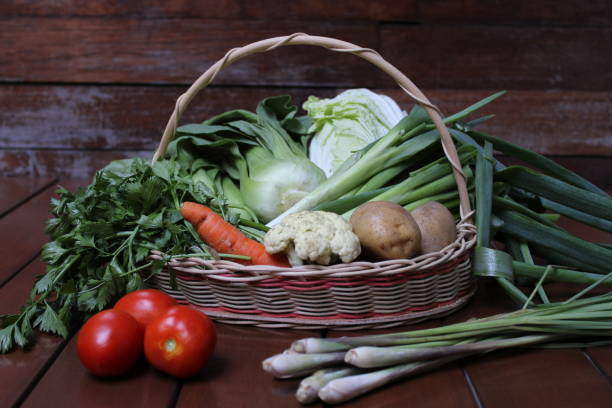 istock Various fresh and organic vegetables in a wicker basket on a wood background 1440218893