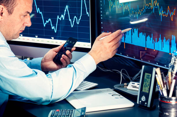 istock Businessman checking stock market data. He using a mobile phone. Analysis economy data on forex earn graph 1440219224