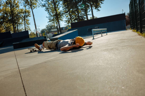 istock Skater lying on ground is skatepark. 1440221204