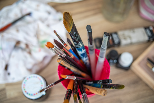 Song with the real artist accessories: pastels, brushes, paints and palette knife