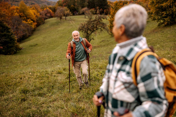 istock Senior hikers enjoying a walk together 1440222317