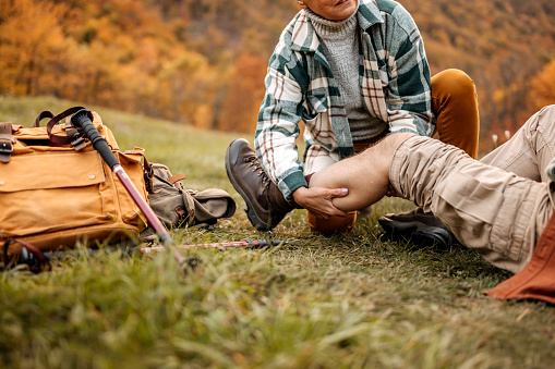 Woman taking care of her injured husband on hiking