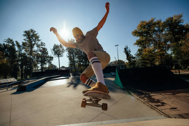 istock Skillful skater jumping with skateboard. 1440223159