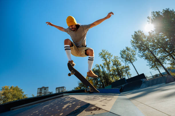istock Skater doing a kick flip in air. 1440223246