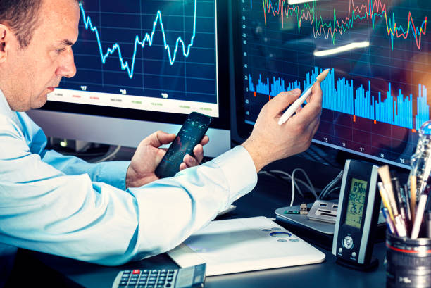 istock Businessman checking stock market data. He using a mobile phone. Analysis economy data on forex earn graph 1440224007