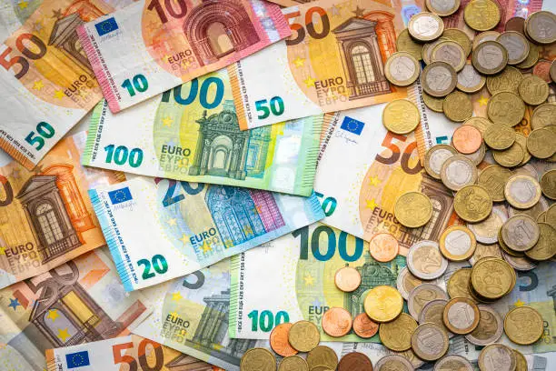 Photo of Euro banknotes and coins background.