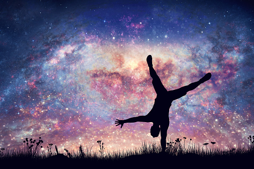 Happy man doing cartwheel on night sky with nebula and stars. Freedom, success, winner. Positive energy. 3d render