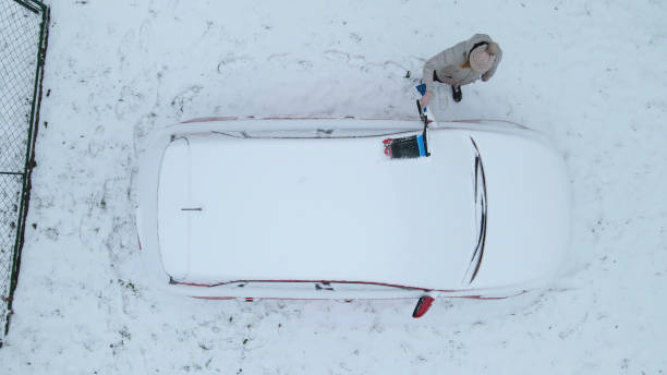 istock Woman scraping ice from her car 1440228351
