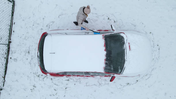 istock Woman scraping ice from her car 1440228421
