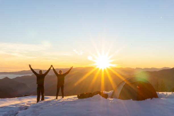 istock Couple celebrating new year during winter camping hike 1440232587