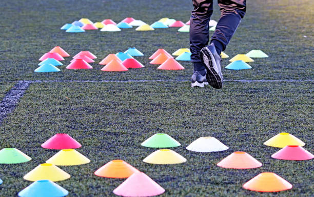 istock A trainer prepares the field with colored cones, to start training 1440232650