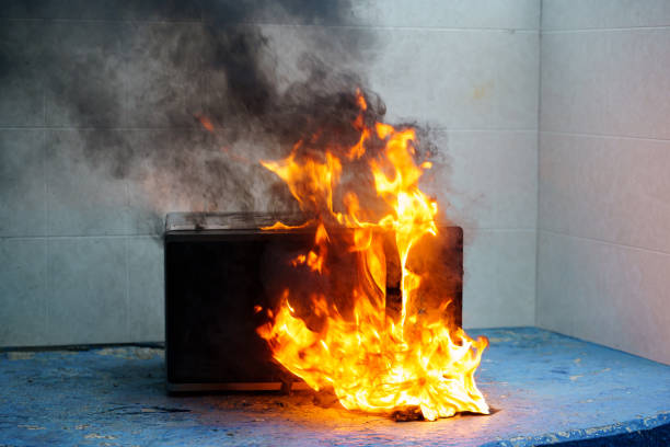 istock microwave oven on fire. the concept of fire in the kitchen. 1440233170