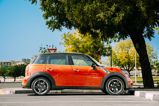 Dubai, UAE, United Arab Emirates - May 25, 2021: Red Color Car Mini Cooper Mini Countryman Parking At City Street. Mini Countryman, also called Mini Crossover in Japan, is a subcompact luxury crossover SUV.