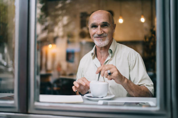 istock Positive senior man drinking coffee in cafe 1440237978