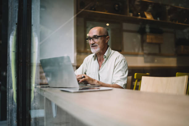 istock Focused businessman working on laptop in cafe 1440238054