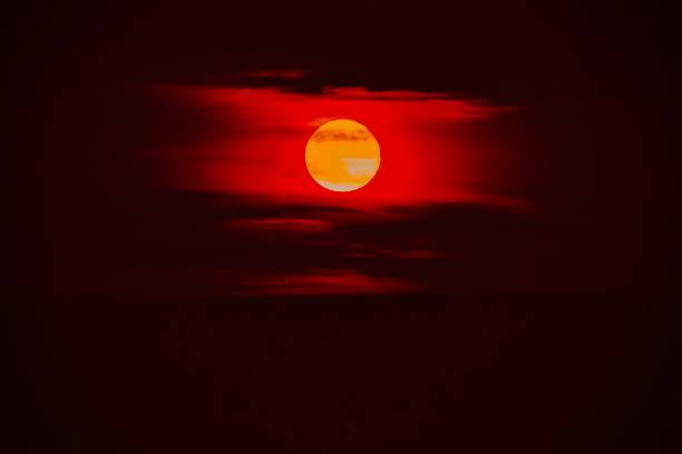 A Vibrant Lunar Full Moon A special moon which occurs after it’s cycle every 3 years, this moon features a bright orange color red full moon stock pictures, royalty-free photos & images