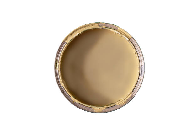 istock Open can with yellow paint on white background, top view 1440240229