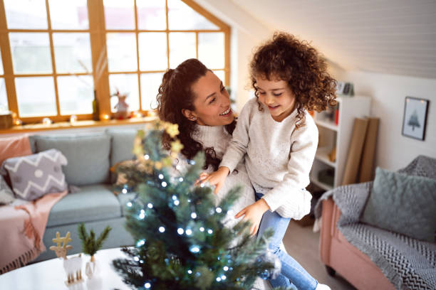 istock Caucasian mother and daughter decorating Christmas tree 1440241422